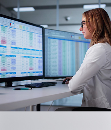 Young professional woman looking as screens of data