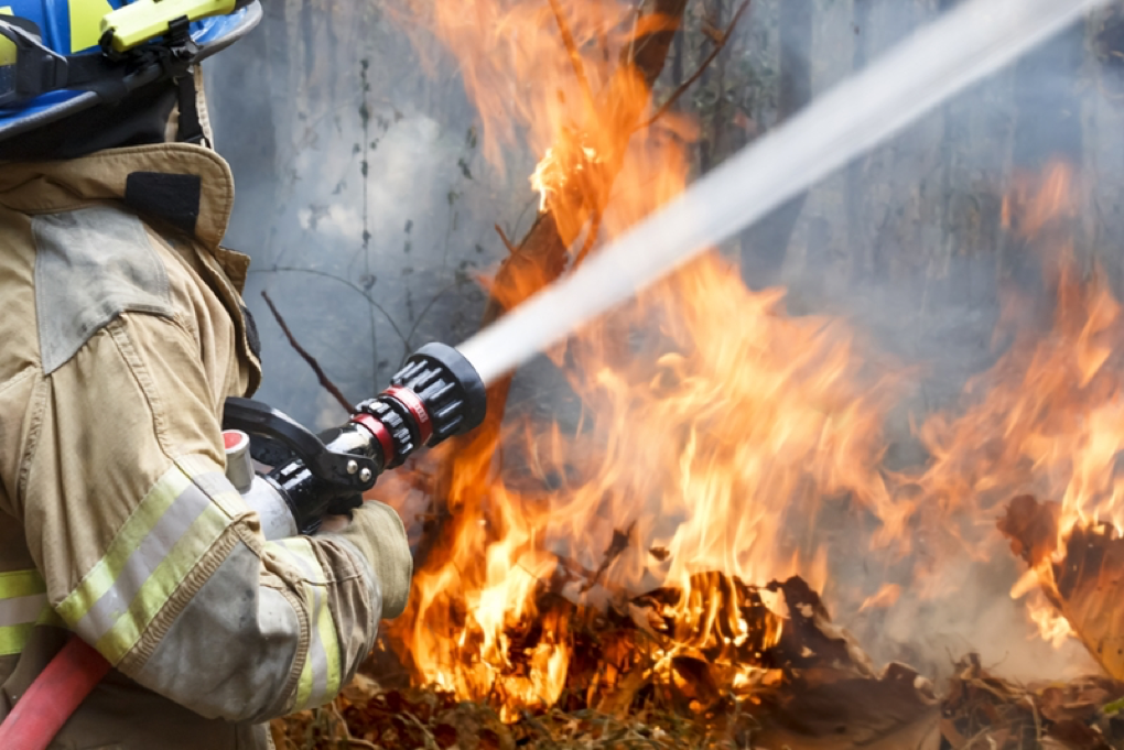 fire fighter spraying fire symbolic for disaster recovery